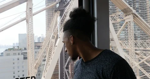Handheld shot of young man inside cable railway wagon in city Stock Footage 120146974