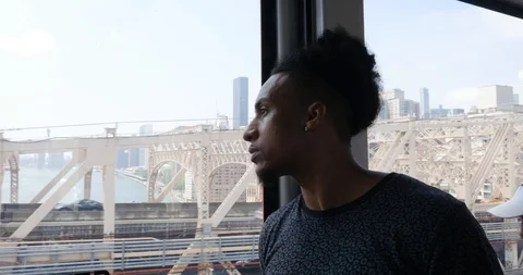 Handheld shot of young man inside cable railway wagon in city Stock Footage 120147930