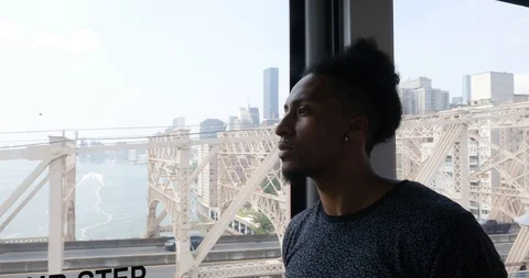 Handheld shot of young man looking out of cable railway wagon Video stock 120148045