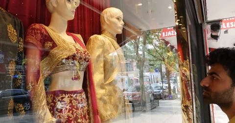 Handheld shot of young man looking at traditional clothing Stock Footage 120149970