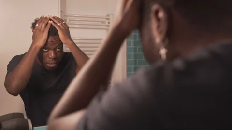 Handheld shot of young man looking at mirror and getting ready in bathroom Stock Footage 120431934