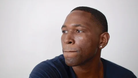 Handheld shot of a young man posing in front of the camera Stock Footage 114880654