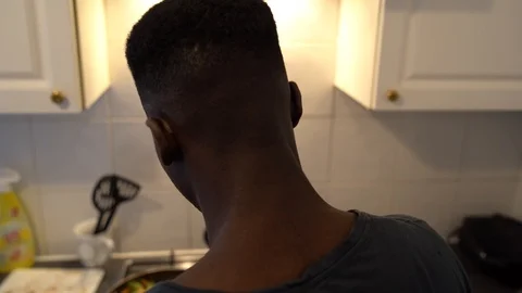 Handheld shot of a young man preparing burritos in the kitchen Stock Footage 114880864