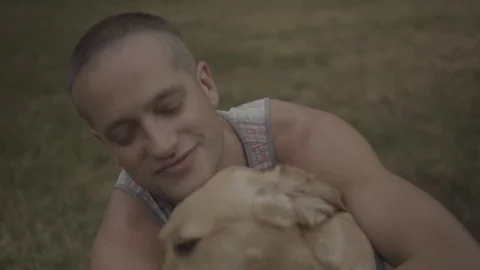 Handheld shot of a young man snuggling his dog Video stock 114881091