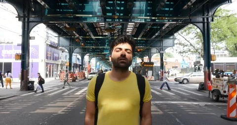 Handheld shot of young man standing on busy city street Stock Footage 120044600