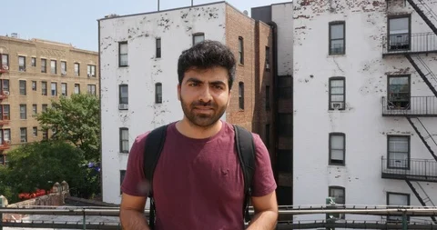 Handheld shot of young man standing on balcony Stock Footage 120149718