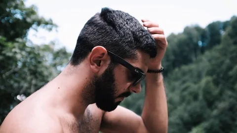 Handheld shot of young man talking while wearing sunglasses Stock Footage 122519778