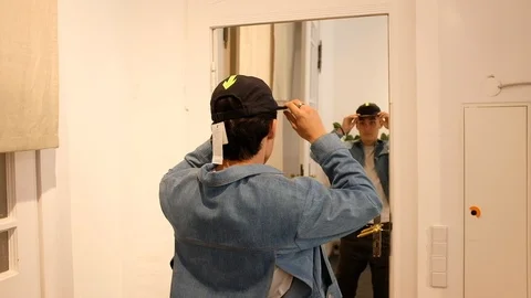 Handheld shot of young man trying on cap Video stock 120426997