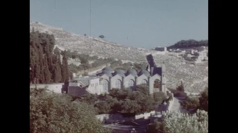 Handheld shots of decorated cathedrals surrounded with greenery, Jordan 1953 Stock Footage 131529594