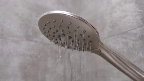 Handheld shower head pouring water in modern bathroom 库存影片 327666367