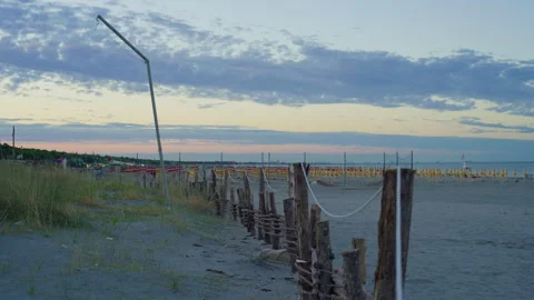 Handheld Side View of Beach Resort and Sea at Sunset Stock Footage 315784002