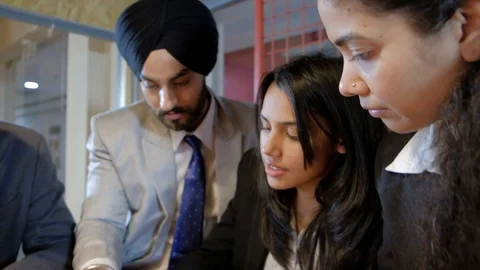 Handheld slow closeup shots pan right to left as there is a busy meeting with In Stock Footage 102322407