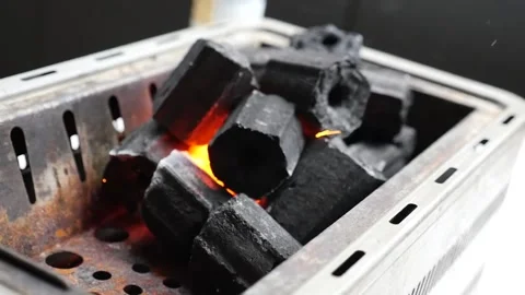 Handheld slow motion of charcoal being lit on fire with sparks flying Stock Footage 155776015