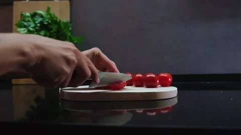Handheld Slow Motion Shot Of Hands Slicing Cherry Tomatoes Stock Footage 242834807
