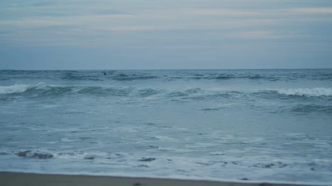 Handheld slow motion shot of waves in blue sea with cloudy sky in background Stock Footage 120291314