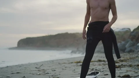 Handheld slow motion of surfer warming up and getting ready for surfing in sea Stock Footage 120291673