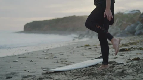 Handheld slow motion of surfer warming up and getting ready for surfing in sea Stock Footage
