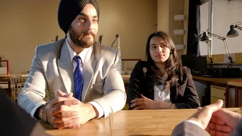 Handheld of Smart, sharp and beautiful Indian business people negotiating, argui Stock Footage 102322874