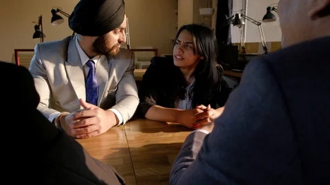 Handheld of Smart, sharp and beautiful Indian colleagues negotiating, arguing an Stock Footage 102322933