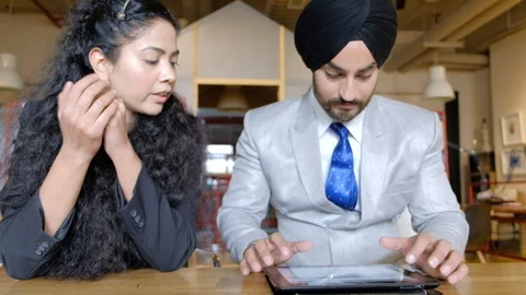 Handheld stabilized shot of Indian colleagues, curly black hair woman and turban Stock Footage 102373214