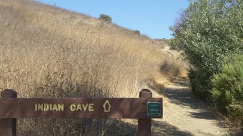 Handheld Static Shot of the "Indian Cave" Sign at Paradise Falls Stock Footage 217514740