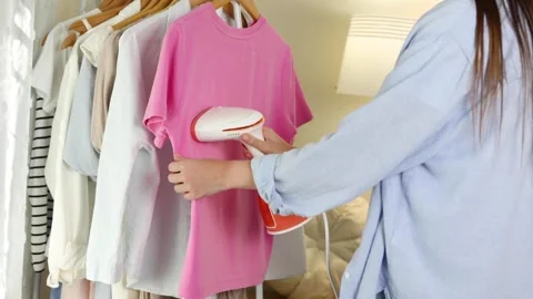 Handheld steamer for ironing clothes at home Stock Footage 345680496