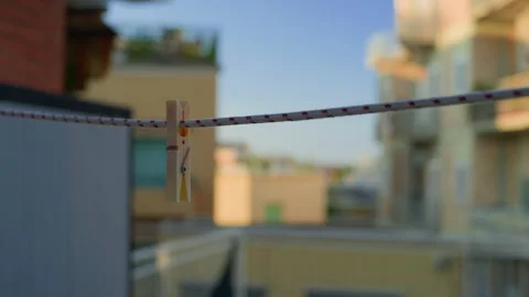 Handheld Still of Clothespin with Housing Complex at Sunset Background Stock Footage 315791648