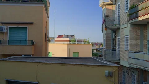 Handheld Still of Housing Complex with Cityscape at Sunset Stock Footage 315810884