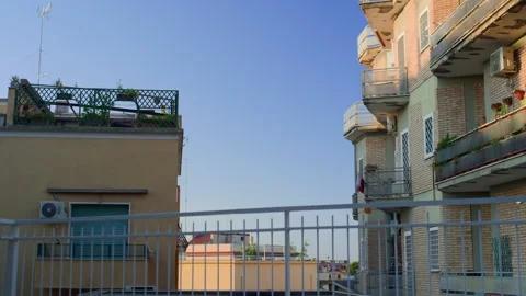 Handheld Still of Residential Complex at Sunset with White Railing Foreground Stock Footage 315753425