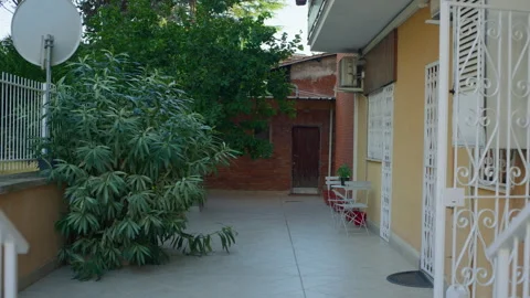 Handheld Still of Shared Apartment Balcony with Potted Plants Stock Footage 315758058