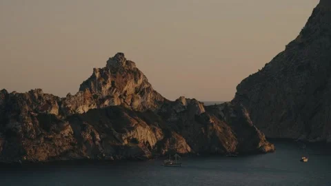Handheld Sunset Boats by Es Vedrá Island, Cala d'Hort, Ibiza, Spain Stock Footage 340318948
