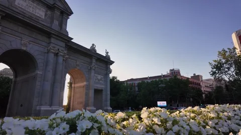 Handheld Sunset View of Puerta de Alcalá Madrid with Blooming Flowers in Stock Footage 341939057