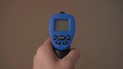 Handheld Temperature Gun Shot at wall, 4k 動画素材 81377957