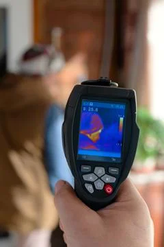 Handheld thermal imaging camera scanning a person Stock Photos