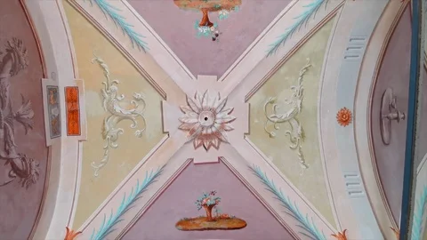 Handheld tilt down shot of historic building interior with painted ceiling Stock Footage 120430495