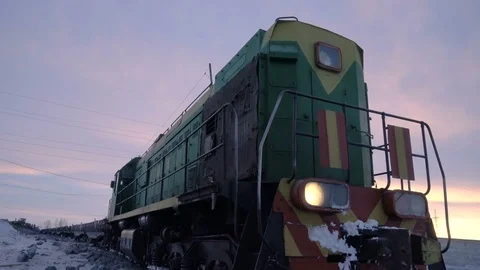 Handheld tracking shot of old diesel locomotive at the unloading station for Video stock 75069321