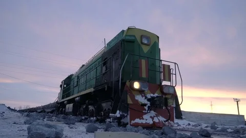 Handheld tracking shot of old diesel locomotive at the unloading station for Video stock 75069381