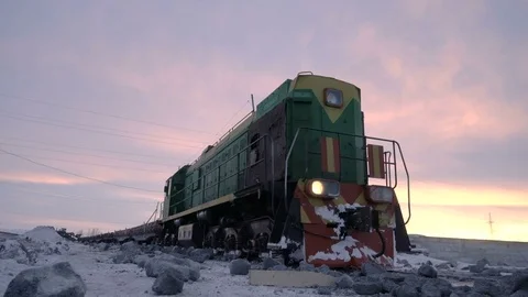 Handheld tracking shot of old diesel locomotive at the unloading station for Video stock 75345612