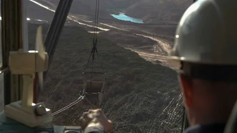 Handheld tracking shot of operating walking excavator by driver in hard hat Stock Footage 87729668