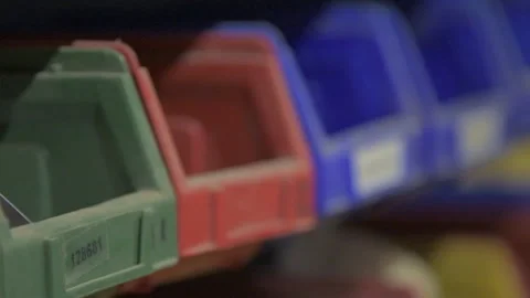 Handheld tracking shot over colourful boxes of tools Slow Motion Stock Footage 131156447