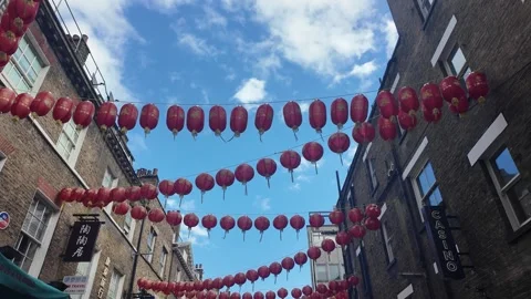Handheld tracking shot under red Chinese lanterns across Soho street sky Stock Footage 346678393