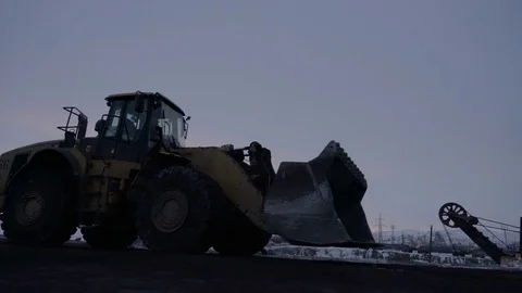 Handheld tracking shot of unloading platform with copper ore at sunset Stock Footage 75261196
