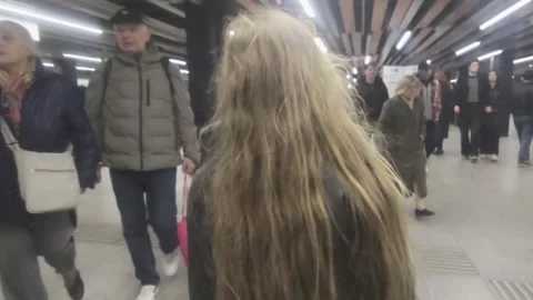 Handheld tracking shot young child walking independently on a subway platform Stock Footage 332790901