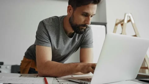 Handheld video of carpenter on a computer and saving results Stock-Footage 134608099