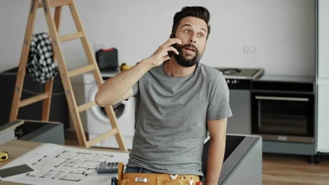 Handheld video of carpenter discussing projects over the phone. Video stock 137086867