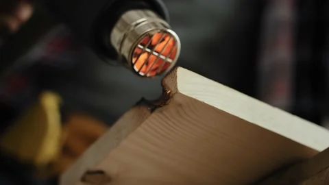 Handheld video of carpenter using wood heat gun Stock Footage 136724291