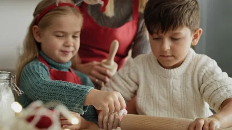 Handheld video of children making gingerbread pastry. Stock Footage 141428443