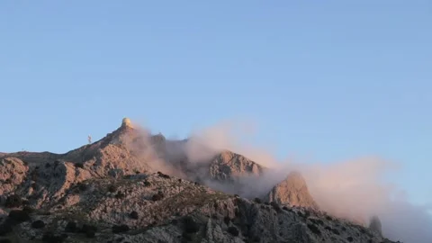 Handheld video of mist hanging in the mountain tops during sunrise Stock Footage 166393516