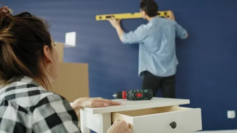 Handheld video of young couple working during moving out Stock Footage 133044958
