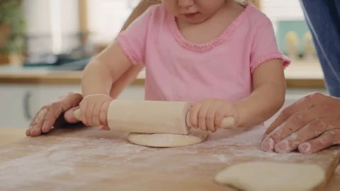 Handheld view of child rolling dough in the kitchen Stock-Footage 124835517